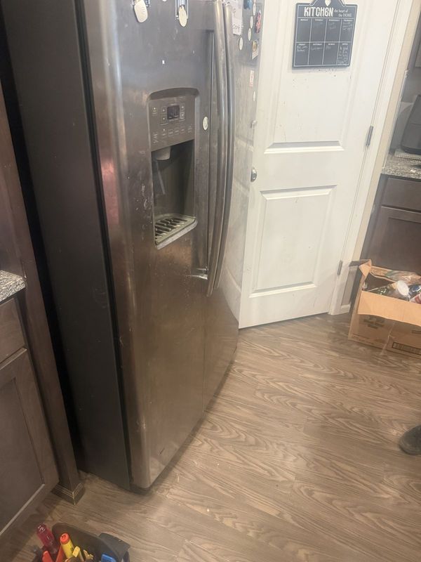 GE side-by-side refrigerator with a door dispenser on a service call